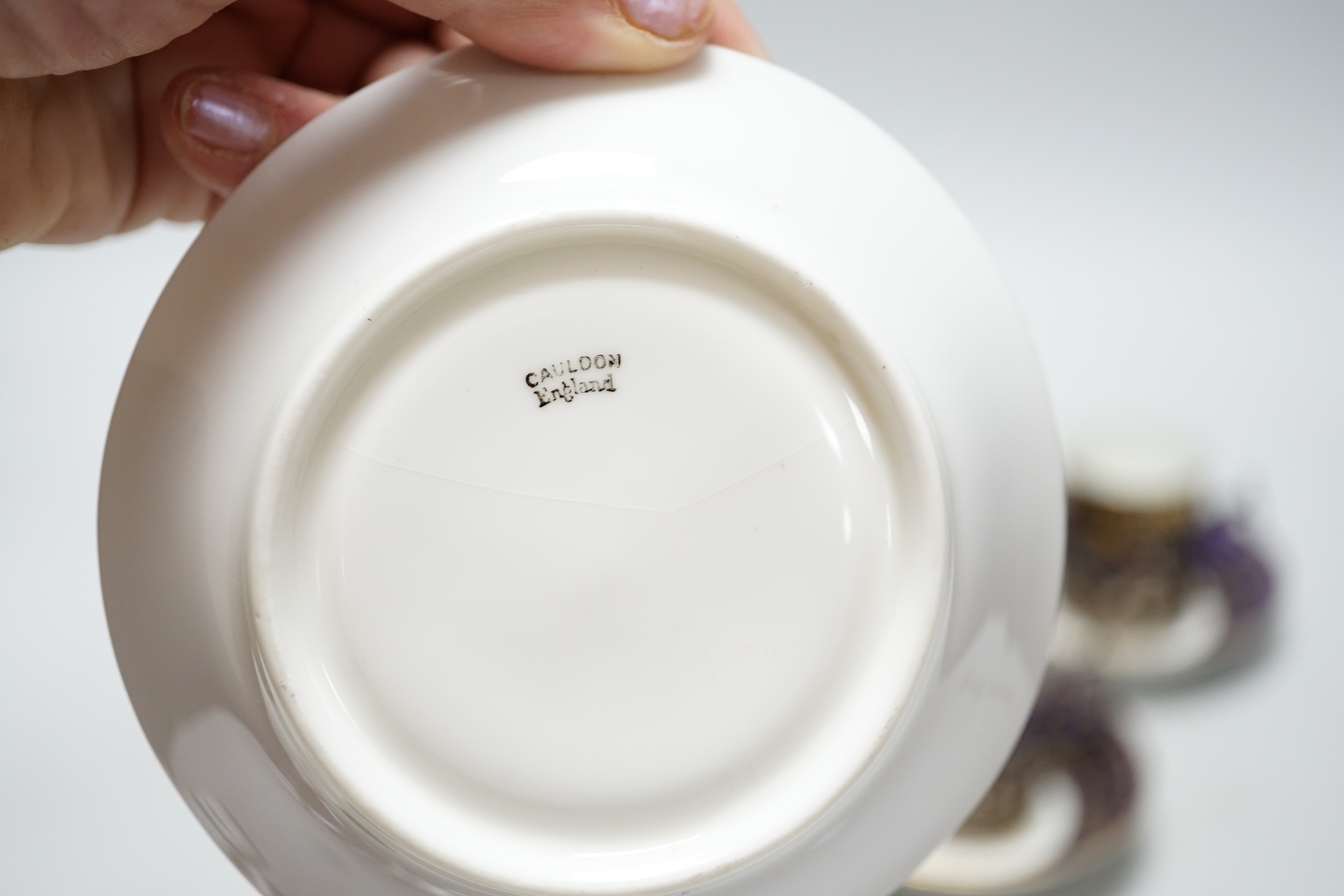 A set of six silver jacketed porcelain cups and saucers